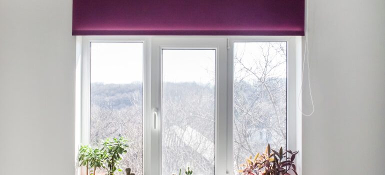 Purple roller blinds installed on a window