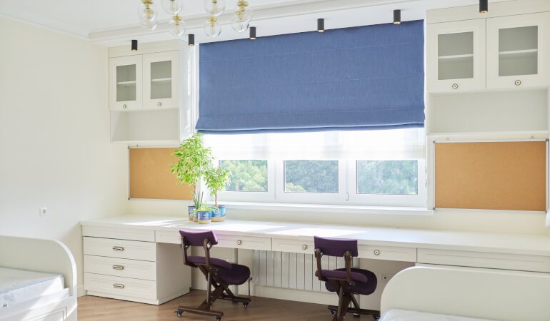 Blue Roman blinds installed in childrens' room
